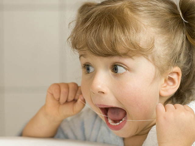 cute little girl flossing