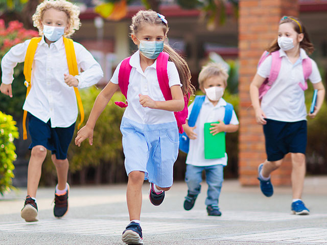 kids running with backpacks and covid masks dr. dennis dunne
